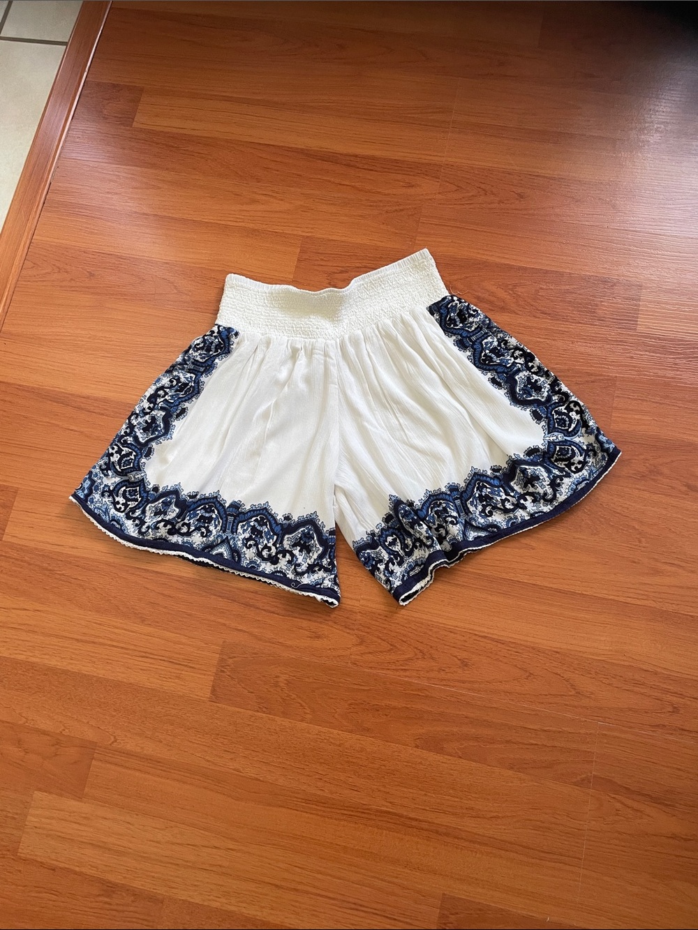 Made for Impulse brand women’s white shorts with blue edged designs